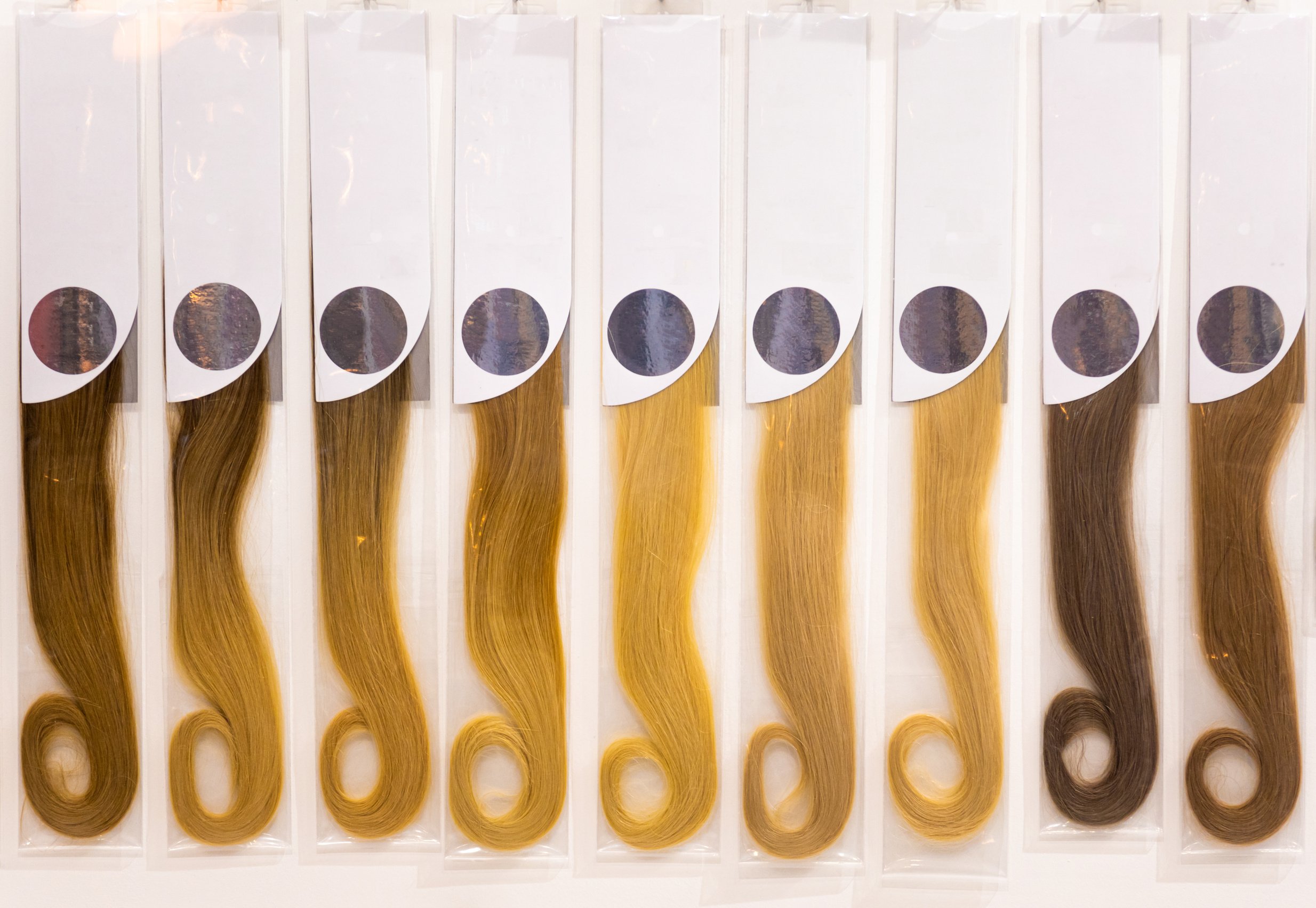 Exhibition of multicolored hair extensions in beauty salon